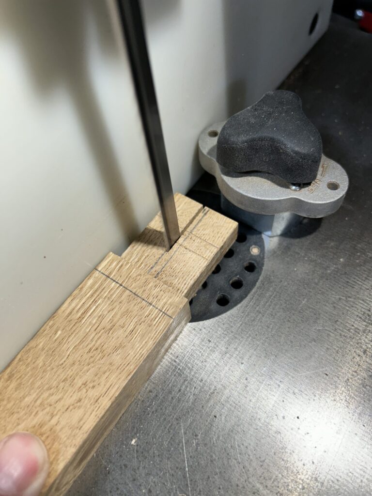 Cutting a slot in the handle tenon at the bandsaw