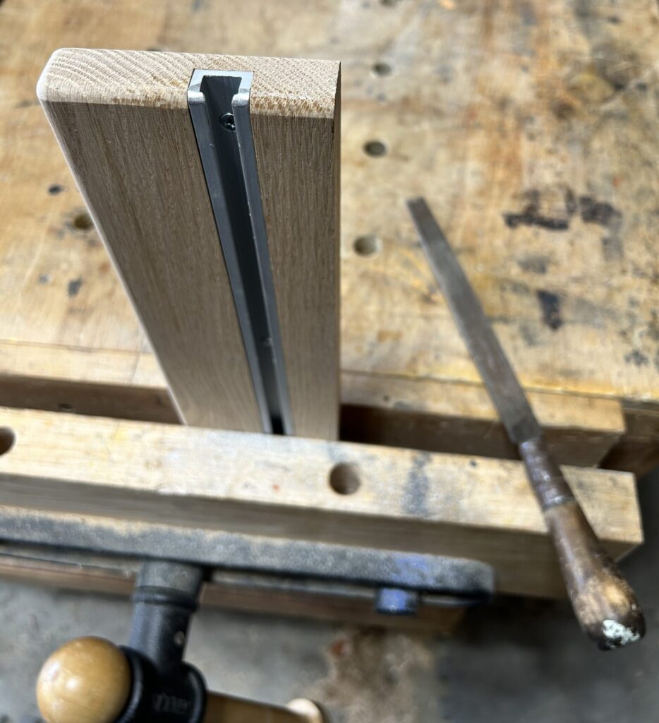 Round the ends of the fence T-track with a file