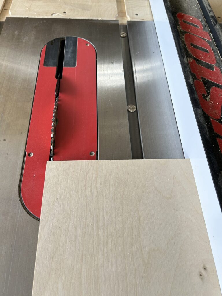 Setting the rip fence in position to determine the base's width